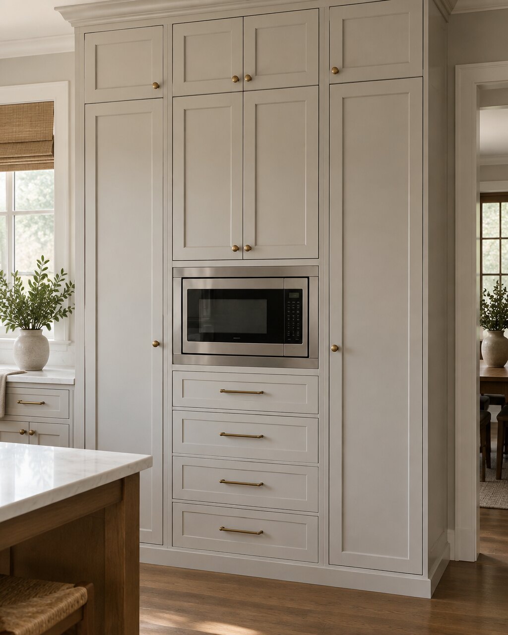 Floor-to-ceiling custom kitchen pantry cabinetry with a built-in appliance niche and drawer storage
